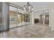 Elegant dining area with a modern chandelier and sliding glass doors to the outdoor space at 1588 E Sweet Citrus Dr, Queen Creek, AZ 85140