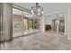 Dining area with stylish light fixture and seamless access to the outdoor patio through sliding doors at 1588 E Sweet Citrus Dr, Queen Creek, AZ 85140