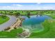 Aerial view of a lush golf course featuring manicured greens, water features, and mature trees under a sunny sky at 1588 E Sweet Citrus Dr, Queen Creek, AZ 85140