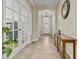 Inviting hallway with neutral colors, tile flooring, glass paned french doors, and decorative lighting at 1588 E Sweet Citrus Dr, Queen Creek, AZ 85140