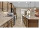 Modern kitchen featuring an island, stainless steel appliances, granite counters, and wooden cabinetry at 1588 E Sweet Citrus Dr, Queen Creek, AZ 85140