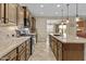 Spacious kitchen featuring granite counters, stainless steel appliances, and an island with a sink at 1588 E Sweet Citrus Dr, Queen Creek, AZ 85140