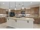 Beautiful kitchen features a large island, wood cabinets, stone countertops, and stainless steel appliances at 1588 E Sweet Citrus Dr, Queen Creek, AZ 85140