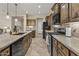 Spacious kitchen with a large island, stainless steel appliances, and wood cabinetry at 1588 E Sweet Citrus Dr, Queen Creek, AZ 85140