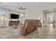 Bright and airy living room with a ceiling fan and a large TV for entertainment at 1588 E Sweet Citrus Dr, Queen Creek, AZ 85140
