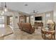 Cozy living room with tile flooring, a ceiling fan, and a leather sofa at 1588 E Sweet Citrus Dr, Queen Creek, AZ 85140