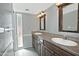 Bright bathroom featuring double sinks, a shower with glass doors, and ample countertop space at 17289 E Kirk Ln, Fountain Hills, AZ 85268