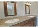 Bathroom featuring double sinks, framed mirrors, modern lighting, and ample storage at 17289 E Kirk Ln, Fountain Hills, AZ 85268