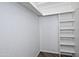 An open walk-in closet featuring shelving and hanging space, providing ample storage for clothing and accessories at 17289 E Kirk Ln, Fountain Hills, AZ 85268