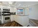 Bright kitchen with white cabinets, stainless steel appliances, and a window overlooking the patio at 17289 E Kirk Ln, Fountain Hills, AZ 85268