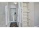 Hallway storage featuring white cabinets and stacked washer and dryer; includes water filtration system at 17289 E Kirk Ln, Fountain Hills, AZ 85268