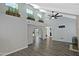 Bright living room with elevated plant shelves, vaulted ceilings, and hardwood floors flowing through the home at 17289 E Kirk Ln, Fountain Hills, AZ 85268