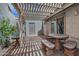 Charming tiled patio with decorative table and benches, covered by a pergola, great for outdoor relaxing at 17289 E Kirk Ln, Fountain Hills, AZ 85268