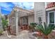 Covered patio with stone pavers, bench seating, lattice-covered pergola, and a lush garden at 17289 E Kirk Ln, Fountain Hills, AZ 85268