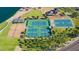 Aerial shot of community amenities: tennis and basketball courts, volleyball court, sandy beach, and shade structures at 17514 W Desert Sage Dr, Goodyear, AZ 85338