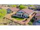 Aerial view of backyard with artificial turf, covered patio, and outdoor furniture in a desert landscape at 17514 W Desert Sage Dr, Goodyear, AZ 85338