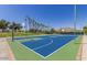 Outdoor basketball court with painted surface and palm trees around in a well-maintained community at 17514 W Desert Sage Dr, Goodyear, AZ 85338