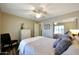 This primary bedroom features hardwood floors, a ceiling fan, and mirrored closet doors at 17514 W Desert Sage Dr, Goodyear, AZ 85338