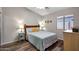 This bedroom features wood-look floors and a window with sunlight at 17514 W Desert Sage Dr, Goodyear, AZ 85338