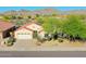 Exterior view of a single-story home showcasing a well-maintained front yard with desert landscaping and mountain views at 17514 W Desert Sage Dr, Goodyear, AZ 85338