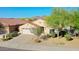 Charming single-story home with a tile roof, desert landscaping, and a two-car garage at 17514 W Desert Sage Dr, Goodyear, AZ 85338