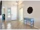 Inviting foyer with neutral tile flooring, a decorative table, and a glimpse of natural light at 17514 W Desert Sage Dr, Goodyear, AZ 85338