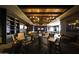 Luxurious game room featuring a pool table, TV, comfortable seating and elegant chandelier lighting at 17514 W Desert Sage Dr, Goodyear, AZ 85338