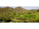 Golf course view surrounded by desert landscape with sand traps, cactus, and distant mountains at 17514 W Desert Sage Dr, Goodyear, AZ 85338