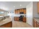 This kitchen features stainless steel appliances, light countertops, and tile flooring at 17514 W Desert Sage Dr, Goodyear, AZ 85338