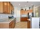 Charming kitchen features wooden cabinets, stainless steel appliances, and tile flooring at 17514 W Desert Sage Dr, Goodyear, AZ 85338