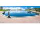 Serene lake view with a brick walkway and decorative lampposts, surrounded by lush landscape at 17514 W Desert Sage Dr, Goodyear, AZ 85338