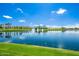 Beautiful lake view with fountains, palm trees, and blue skies; a peaceful community landscape at 17514 W Desert Sage Dr, Goodyear, AZ 85338