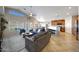 Open-concept living room with a spacious layout, tile flooring, and access to the kitchen and dining area at 17514 W Desert Sage Dr, Goodyear, AZ 85338