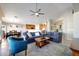 Bright living room with couches, open floor plan, with view to the kitchen and dining area at 17514 W Desert Sage Dr, Goodyear, AZ 85338
