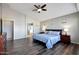 Bright main bedroom with hard floors, ceiling fan, ensuite, and lovely natural light through the window at 17514 W Desert Sage Dr, Goodyear, AZ 85338