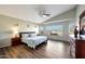 Spacious main bedroom features a vaulted ceiling, wood floors, large windows and a ceiling fan at 17514 W Desert Sage Dr, Goodyear, AZ 85338