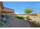 Inviting covered patio overlooking the manicured lawn, with mountain views in the background at 17514 W Desert Sage Dr, Goodyear, AZ 85338