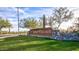 Golf Village community entrance sign with lush green lawn and desert foliage at 17514 W Desert Sage Dr, Goodyear, AZ 85338