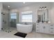 Luxurious bathroom with a soaking tub, separate shower, and modern fixtures at 1845 N 103Rd St, Mesa, AZ 85207