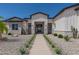 Beautiful home featuring desert landscaping with a walkway to a stylish front entrance at 1845 N 103Rd St, Mesa, AZ 85207
