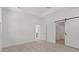 Bright bedroom with a sliding barn door, offering a stylish and functional space for relaxation and comfort at 20332 W Sells Dr, Buckeye, AZ 85396