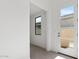 A well-lit entryway featuring white walls and a stylish three-paneled door at 20332 W Sells Dr, Buckeye, AZ 85396