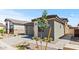 A modern home featuring a gray garage door and neutral stucco and siding, complemented by a brick driveway at 20332 W Sells Dr, Buckeye, AZ 85396