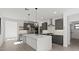 Spacious kitchen featuring gray cabinets, stainless steel appliances, a large island and an open layout at 20332 W Sells Dr, Buckeye, AZ 85396