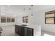 A kitchen featuring a large island with stainless steel appliances, pendant lights, and tile flooring at 20332 W Sells Dr, Buckeye, AZ 85396
