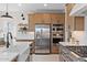 Bright kitchen featuring a large island, stainless steel appliances, ample wood cabinets, and a breakfast nook at 20332 W Sells Dr, Buckeye, AZ 85396