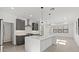 A spacious kitchen featuring an island, stainless steel appliances, gray cabinetry, and pendant lighting at 20332 W Sells Dr, Buckeye, AZ 85396