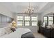 Primary bedroom featuring natural light, a stylish chandelier, and comfortable furnishings at 20332 W Sells Dr, Buckeye, AZ 85396