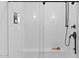Sleek shower featuring white subway tile, black fixtures, and a built-in bench for a spa-like experience at 20332 W Sells Dr, Buckeye, AZ 85396