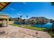 Well maintained backyard with a view of the lake, palm trees, boats, and mountains in the background at 20713 N 56Th Ave, Glendale, AZ 85308